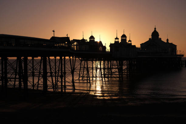 The pier in Eastbourne, East Sussex at sunrise Clear skies and rising sun behind the pier in Eastbourne, East Sussex eastbourne pier photos stock pictures, royalty-free photos & images