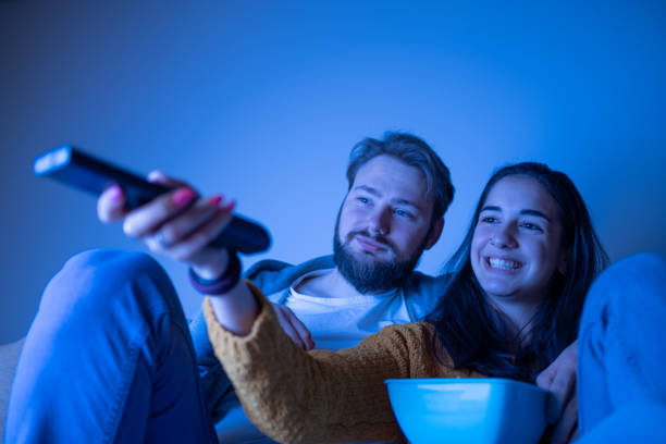 istock Young couple enjoy movie night 1311119676