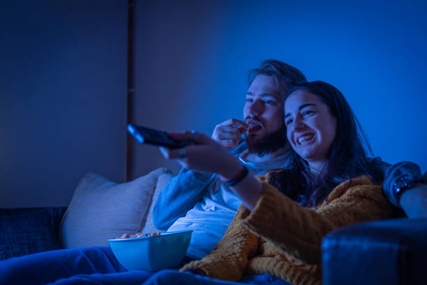 istock Couple eating popcorn and watching movie 1311119867