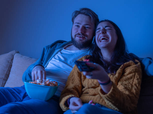 istock Young couple sitting and watching comedy 1311119951