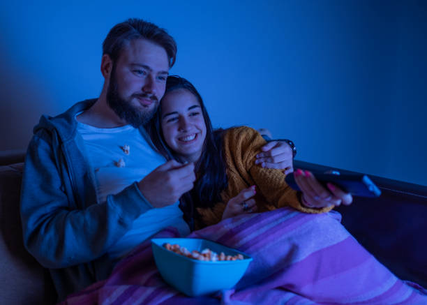 istock Couple snuggled and watching television 1311120010