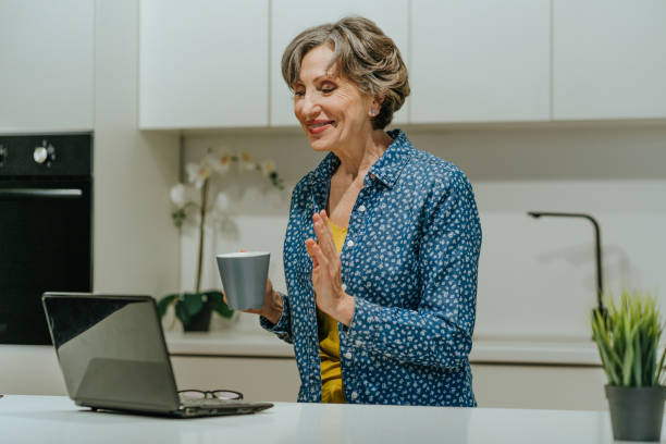 istock Stylish senior woman using laptop for video call 1311120910