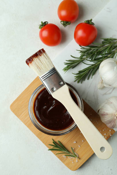 istock Concept of cooking with barbecue sauce on white textured table 1311121015