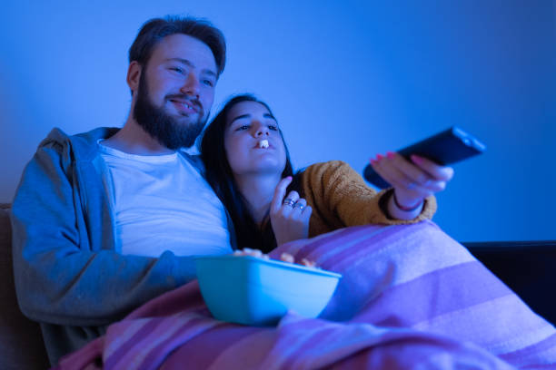 istock young couple snuggled and watching television 1311121203