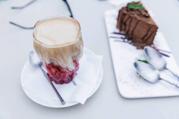 istock Coffee cup and chocolate cake on white plates 1311121453