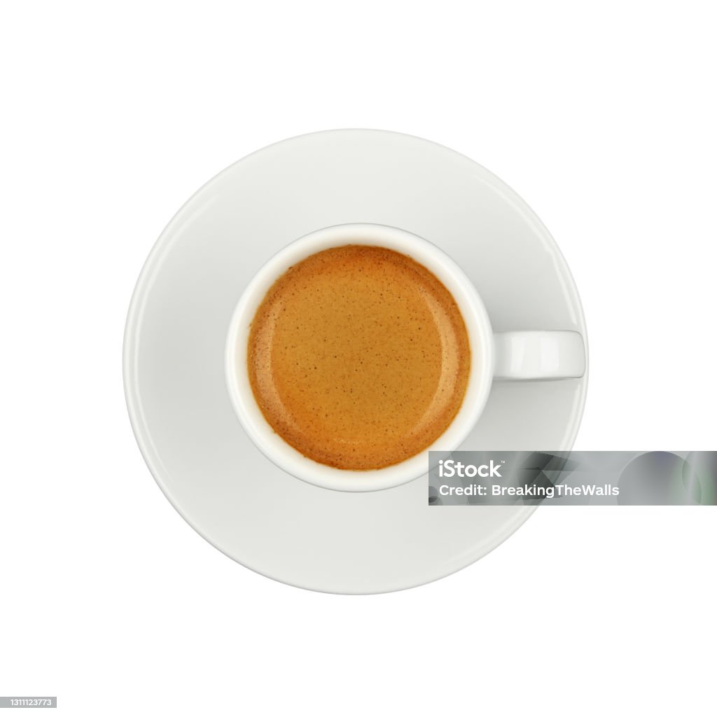 White cup of espresso coffee on saucer isolated Close up one white cup full  of espresso coffee, on saucer, isolated on white background, elevated top view, directly above Espresso Stock Photo