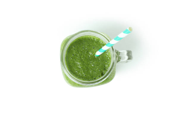 istock Mason jar of green smoothie isolated on white background 1311123933