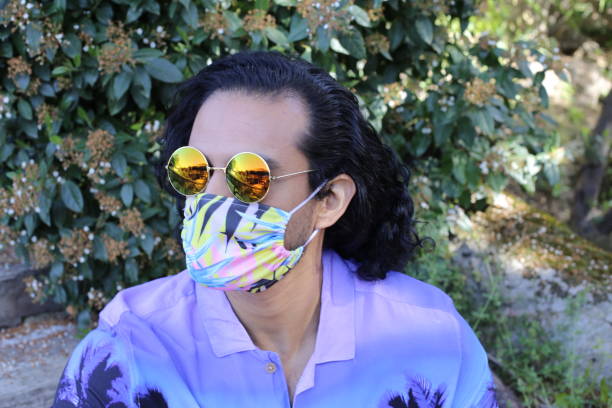 istock Male model posing with floral protective mask 1311124040