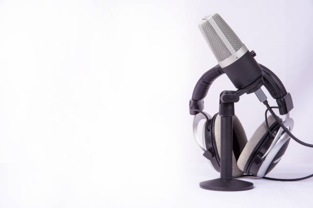 istock home work, professional condenser microphone and headphones on white background, high key portrait, selective focus. 1311124126