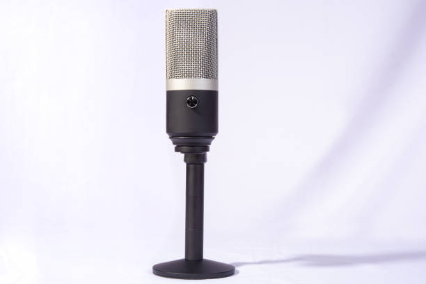 istock professional condenser microphone on a pedestal isolated with white background, selective focus. 1311124129