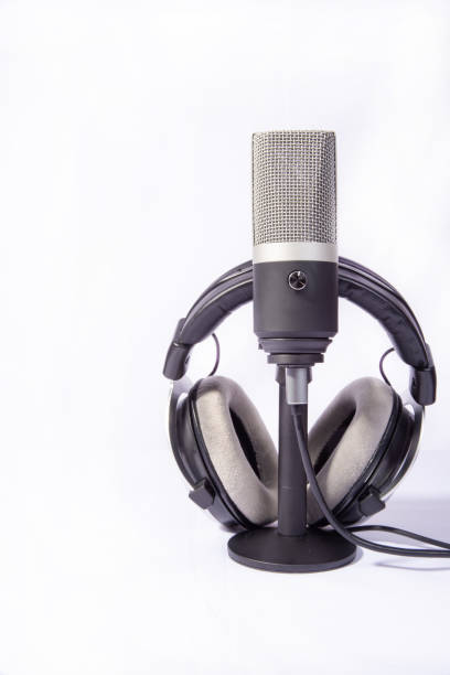 istock home work, professional condenser microphone and headphones on white background, high key portrait, selective focus. 1311124217