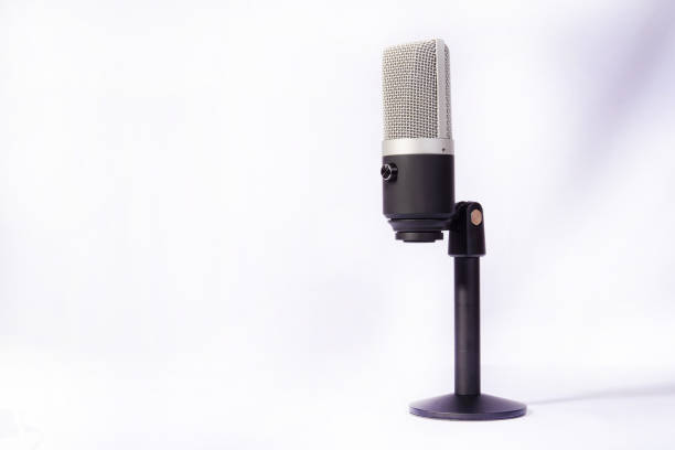 istock professional condenser microphone on a pedestal isolated with white background, selective focus. 1311124314