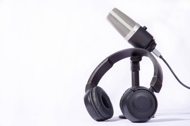 istock home work, professional condenser microphone and headphones on white background, high key portrait, selective focus. 1311124352