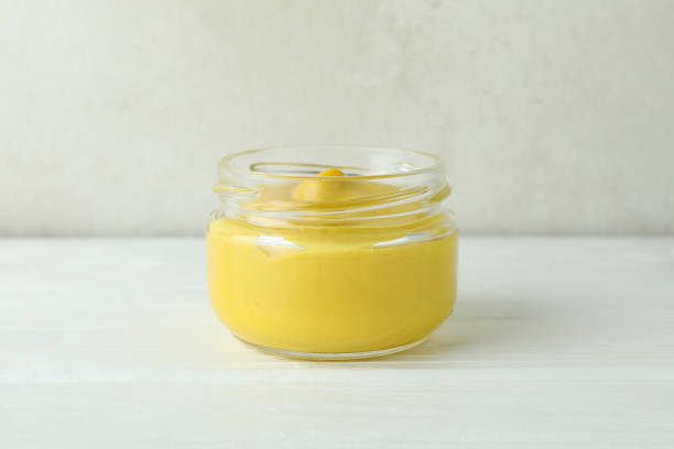 istock Glass jar with mustard on white wooden table 1311124519