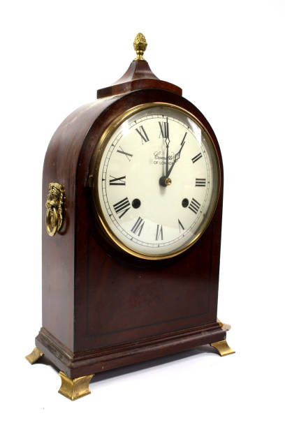 istock A Wooden Timepiece Mantle Clock on White Background 1311125983