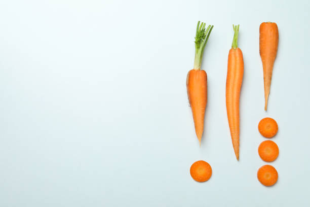 istock Flat lay with carrot slices on white background 1311126785