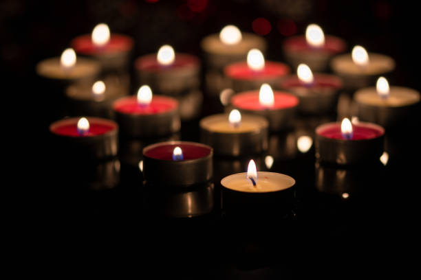 istock background with tea light candles shines in the dark. 1311127247