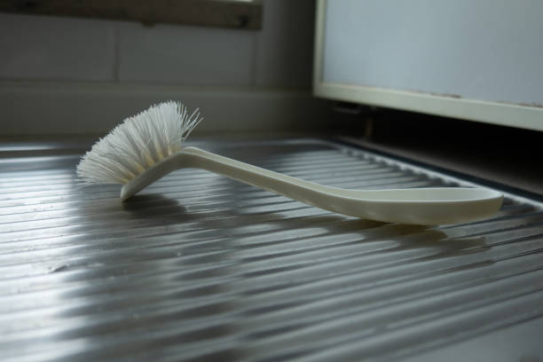 istock white dish brush lies on the kitchen sink 1311127380