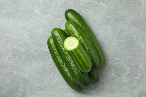 istock Ripe cucumbers on gray background, top view 1311127541
