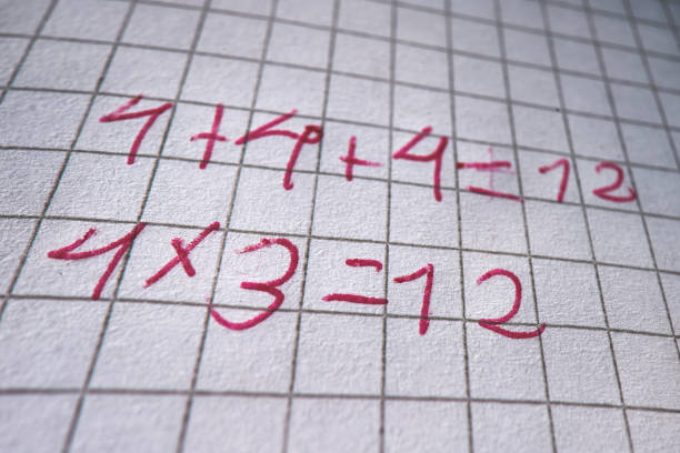 istock Mathematical calculations of a child written with red pen 1311128309