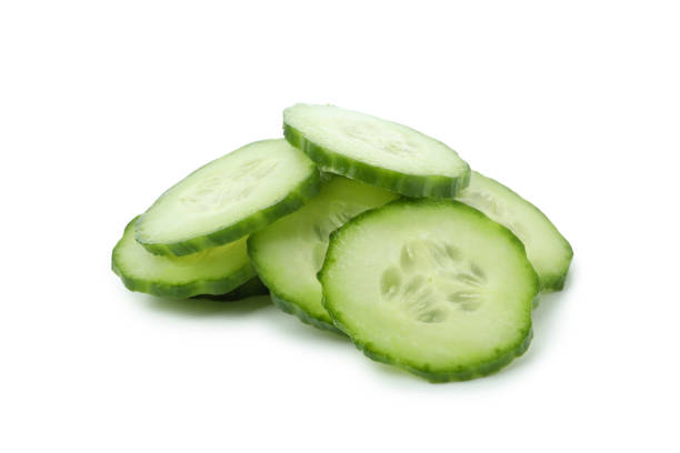 istock Ripe cucumber slices isolated on white background 1311128508