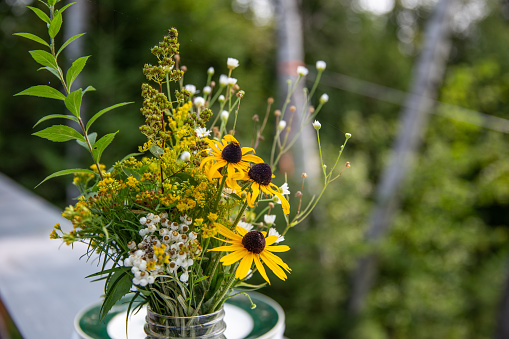 wild flower bouquet in a glass jar in summer