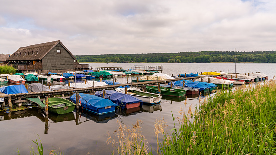 Near Guestrow, Mecklenburg-Western Pomerania, Germany - June 12, 2020: Houses and boats at the Inselsee (Island Lake)