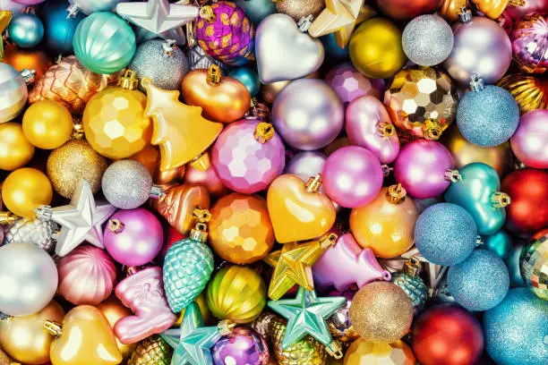 Photo of Many multi-colored christmas toys background texture. Top view.