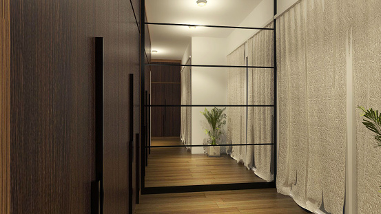Fitting Room With Wooden Wardrobe Clothes And Wall Mirror Paneling. Walk in closet in modern and luxurious style.