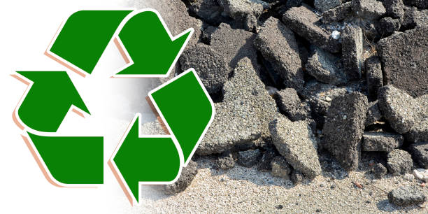 istock Cracked asphalt pieces after demolition of a road surface in a construction site for renovation ready to be recycled as special waste 1311133038