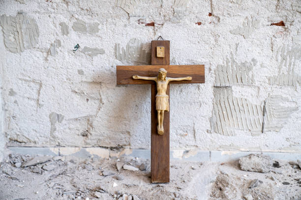 istock Jesus on Cross against rough brick wall 1311135660