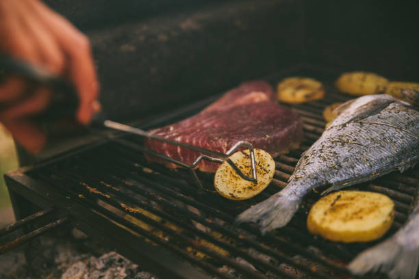 istock cooking fish and potatoes on grill 1311135894