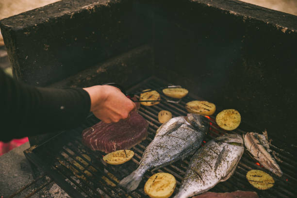 istock cooking fish and potatoes on grill 1311135895