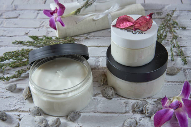 istock Two handmade cream jars decorated with aromatic herbs and apricot pits. 1311136728