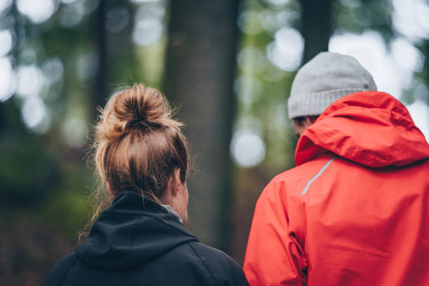 istock Young couple hike through forest in the morning 1311136828