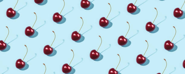 istock Bright pattern of ripe cherries on a blue background. 1311136882