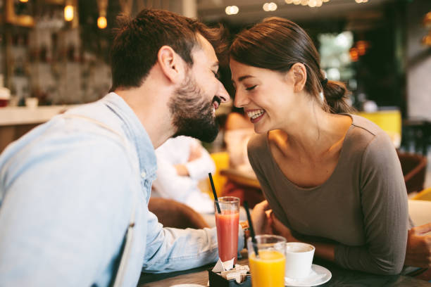 istock Young happy couple at a date in cafe 1311137011