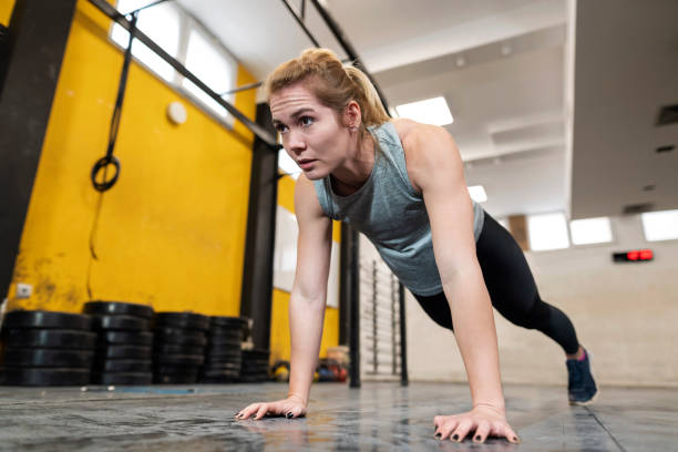 istock Female athlete doing push-ups in the gym 1311139853