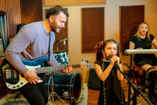 Photo of portrait of family band rehearsing in studio