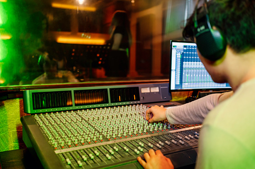 sound engineer working at mixing panel in the recording studio