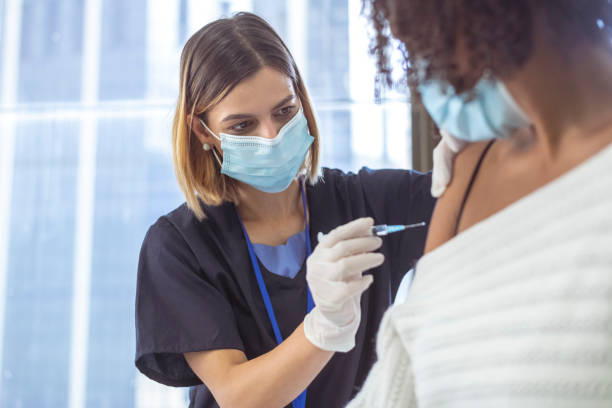 istock Nurse injects patient with COVID-19 vaccine 1311141256