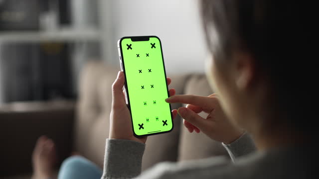 Woman using Smart phone with green screen