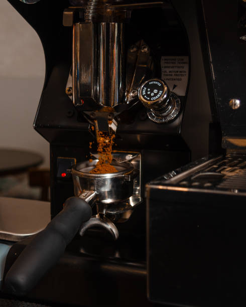 istock Molin of coffee beans dropping coffee ground into the filter holder. 1311142377