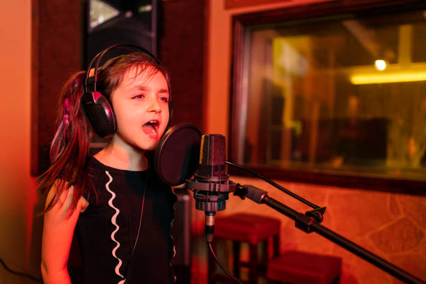istock child singer recording song in professional music studio 1311142601