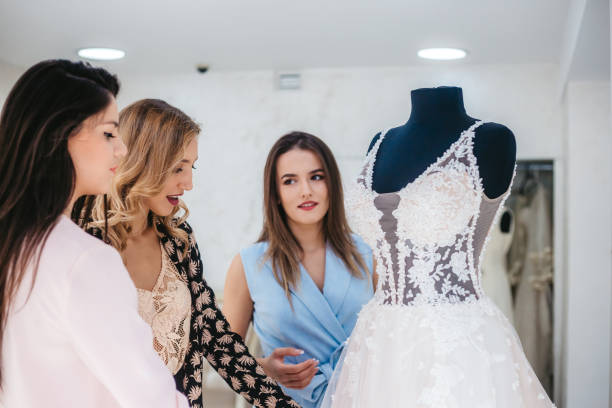 istock Women having fun during wedding dress shopping 1311146271
