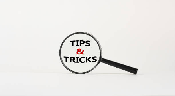 istock Tips and tricks symbol. Magnifying glass with words 'Tips and tricks'. Beautiful white background. Business, tips and tricks concept. Copy space. 1311147500