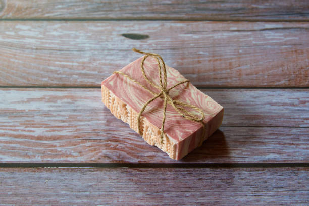istock Pink textured handmade soap on a gray background. 1311147528