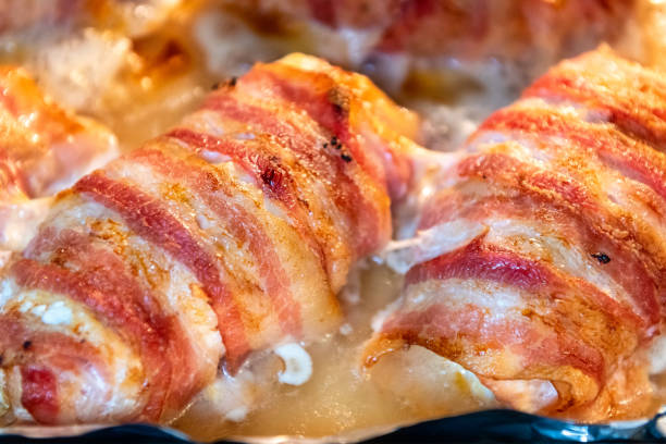 istock Chicken breasts wrapped in bacon inside an oven 1311147648