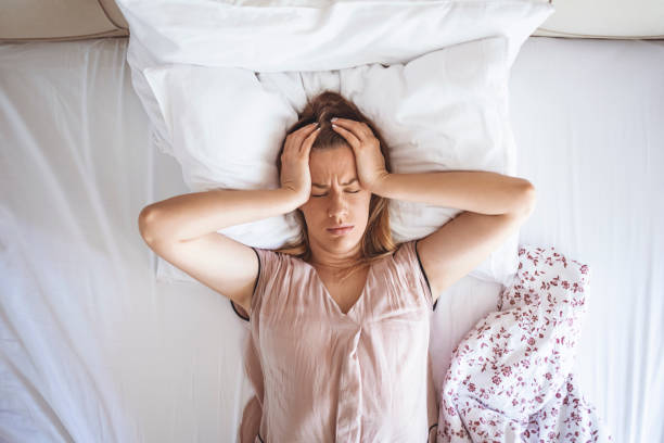 istock Desperate girl suffering insomnia trying to sleep 1311155182