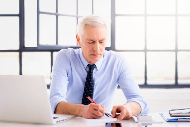 istock Elderly businessman working in the office 1311157283